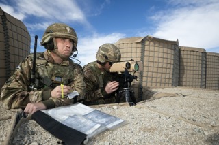 Personnel look out of binoculars.